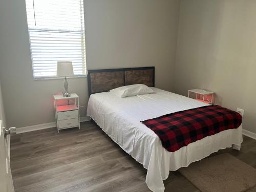 a bedroom with a bed with a plaid blanket at Dolphin Room in Tampa