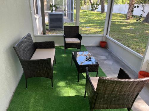 a patio with chairs and a table and a table and chairs at Dolphin Room in Tampa