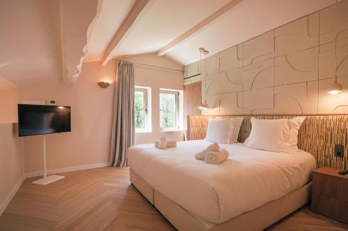 a bedroom with a bed with two teddy bears on it at Casa Liana Saint-Tropez in Saint-Tropez