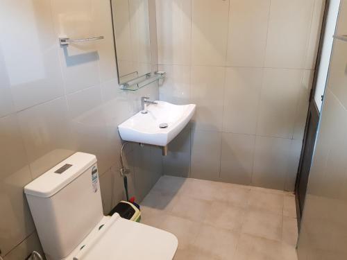 a bathroom with a toilet and a sink at Shalom View Homestay in Kandy