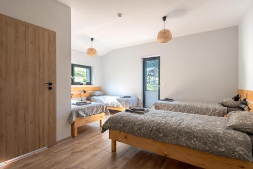 a bedroom with two beds and a door at Dom Przebudzeń in Porąbka