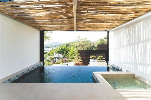 a swimming pool in the middle of a house at Tivoliville Spa N Poolvilla in Pocheon