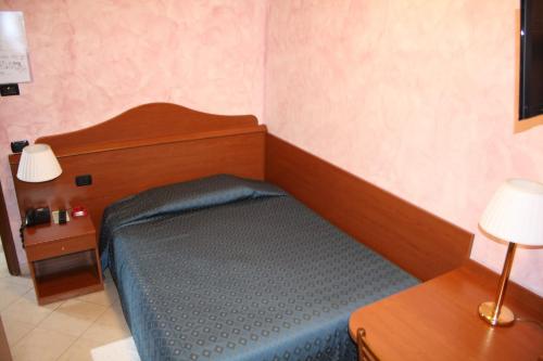 a small bedroom with a bed and a table at Italia Risorta in Arsiero