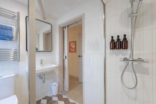 a bathroom with a shower and a sink at The Barn at Thorpewood in Thorpe Market