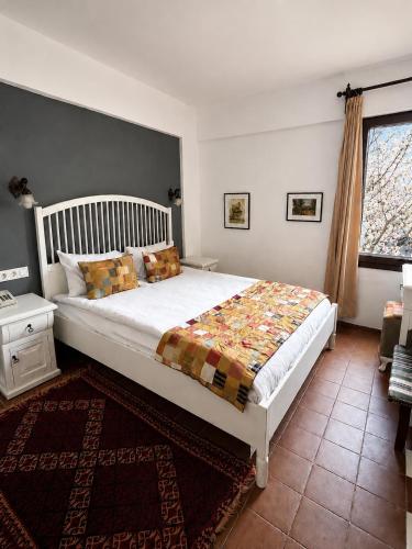 a bedroom with a large bed and a window at Hotel Kalehan in Selçuk