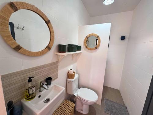 a bathroom with a sink and a toilet and a mirror at Villa Massalia Essaouira in Essaouira