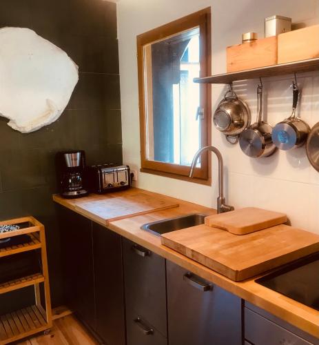 a kitchen counter with a sink and a window at le Pullman in Deauville