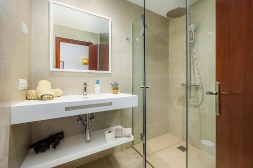 a bathroom with a sink and a shower at Cala Figuera Apartment 4b in Cala Figuera