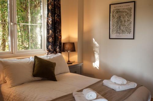 a bedroom with a bed with towels on it at Saltspring Lodge in Oban