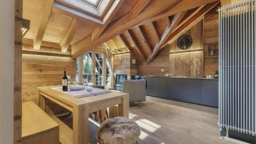 a kitchen with a table with a bottle of wine at Alpen Chalet in Ponte di Legno