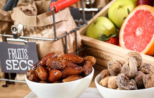 two bowls of nuts and fruit on a counter at Ibis Barcelona Mollet in Mollet del Vallès