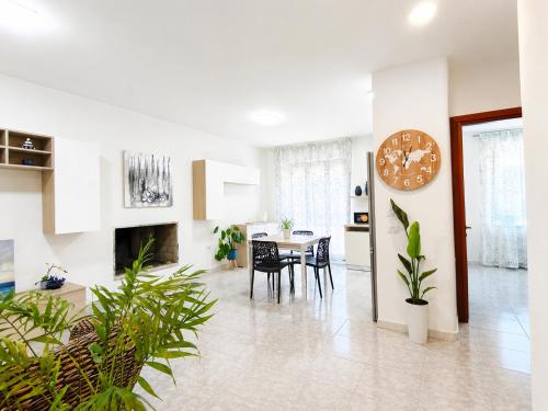 a living room with a table and chairs at Center Room Tortolì wifi, AC, free parking, city center at 100 m in Tortolì