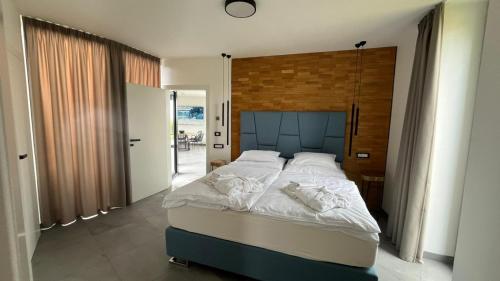 a bedroom with a large bed with white sheets at vila Kořenec in Kořenec