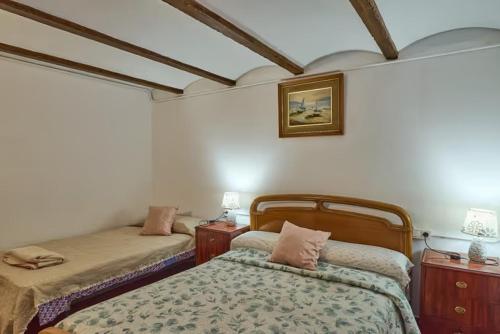 a bedroom with two beds and two tables and a picture at VTAR CASILLA MIGUELIN in Montilla