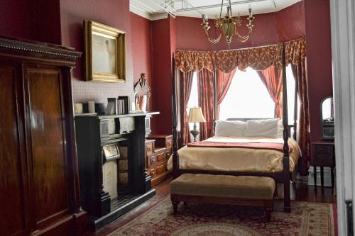 a bedroom with a bed and a window at The Roses Heritage Inn in St. John's