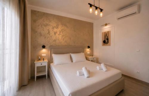 a bedroom with a large white bed with two night stands at Apartman Ivan with pool in Zagvozd