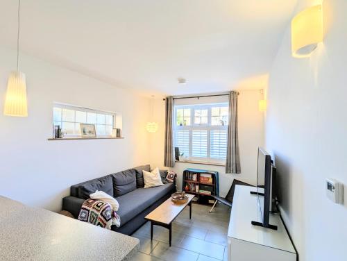 a living room with a couch and a tv at New Barnet Fresh Apartment in New Barnet