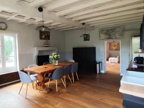 a dining room with a wooden table and chairs at Pallancheloc in Amions