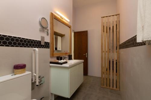 a bathroom with a sink and a mirror at Ayuda Sanctuary Boutique Negombo in Negombo
