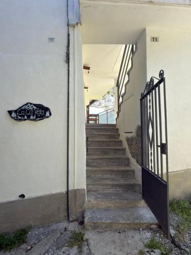 a stairway with a sign on the side of a building at La ca veja in Locana