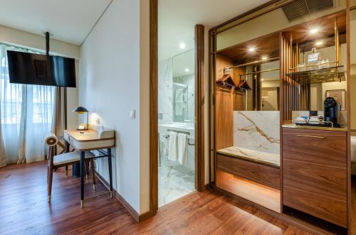 a bathroom with a vanity and a sink and a mirror at TURIM Lisboa Hotel in Lisbon