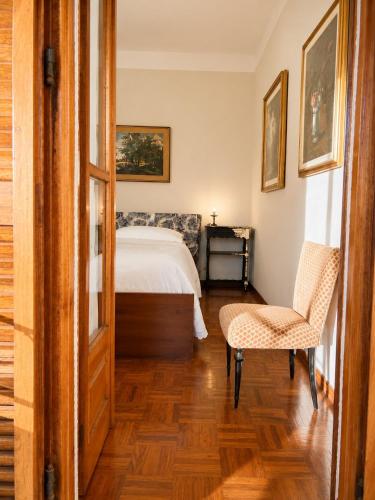 a bedroom with a bed and a chair at Charm Studio - Large private terrace, Masserano in Masserano