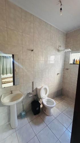 a bathroom with a toilet and a sink at Casa California - espaçosa in Formosa