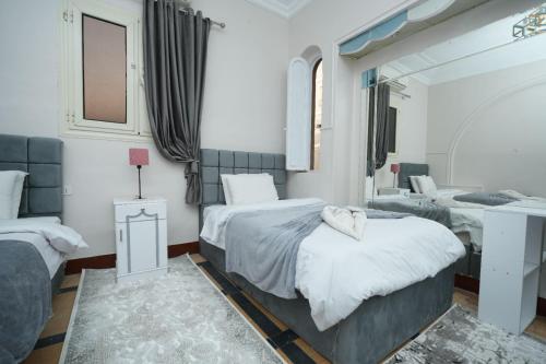 a bedroom with two beds and a mirror at Castle hostel in Cairo