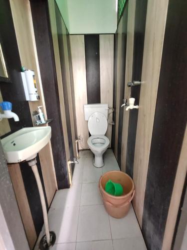 a small bathroom with a toilet and a sink at Sunrise Lodge in Varanasi