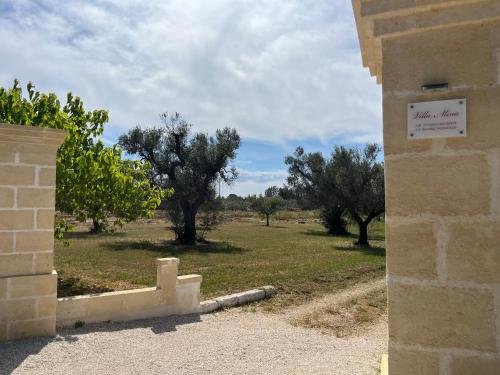 a corner of a building with trees in a field at Villa Mina in Serranova