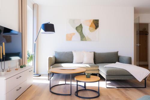 a living room with a couch and two tables at Strandläufer 1 4 - Kellenhusen in Kellenhusen