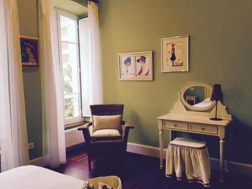 a bedroom with a dressing table and a mirror at Hotel La Balastrera in Ribadeo