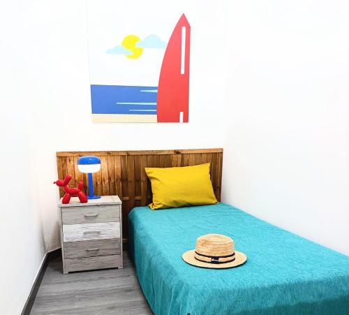 a bedroom with a bed with a hat on it at Nido De Mar in Santidad