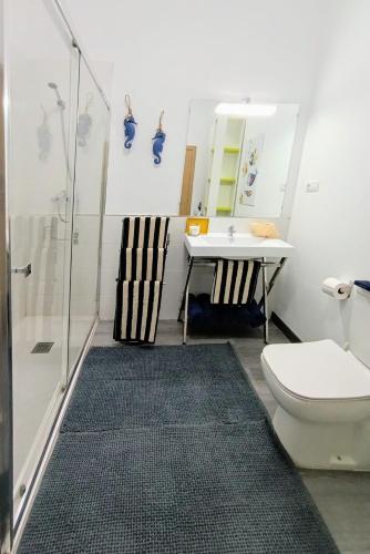 a bathroom with a shower and a sink and a toilet at Nido De Mar in Santidad