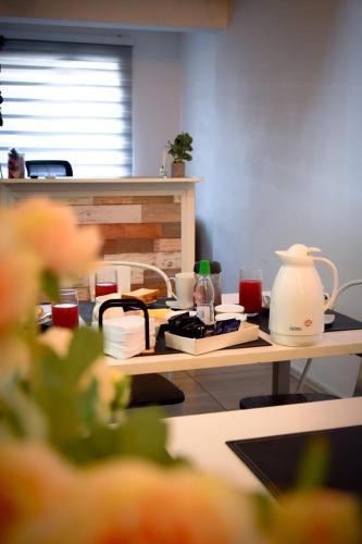 a kitchen with a table with a tea pot on it at Hostal Madrid in Talca