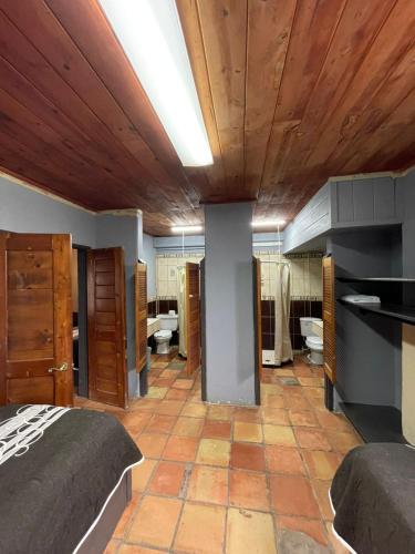 a bedroom with a bed and a wooden ceiling at Rm Dorm in San Quintín