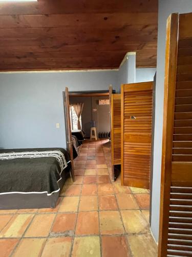 a bedroom with two beds and a tiled floor at Rm Dorm in San Quintín