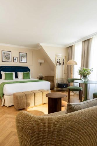 a hotel room with a large bed and furniture at Hotel Du Flaneur in Paris