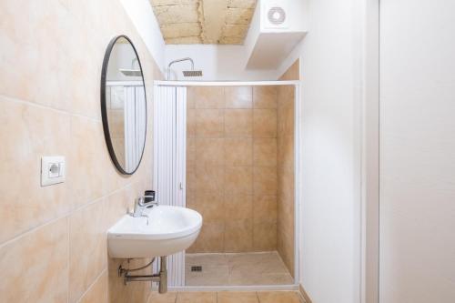 a bathroom with a sink and a mirror at Biancolino Apartments in Nardò