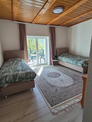 two beds in a room with a window at Plav`s dream in Plav