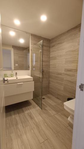 a bathroom with a shower and a sink and a toilet at One suite los corales in Punta Cana