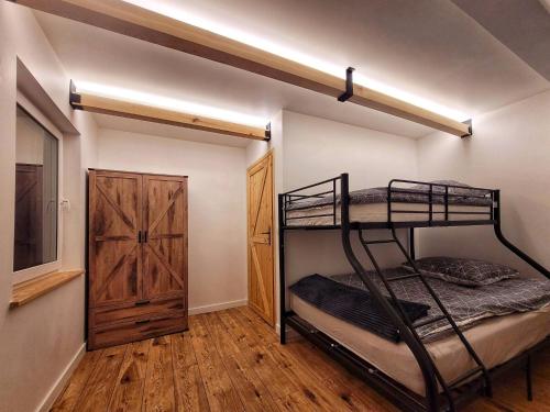 a bedroom with a bunk bed and a closet at BLUE Reset in Ruciane-Nida