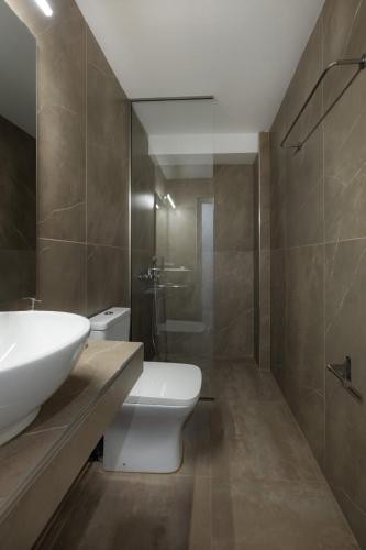 a bathroom with a sink and a toilet and a shower at DION APARTMENTS in Paleros