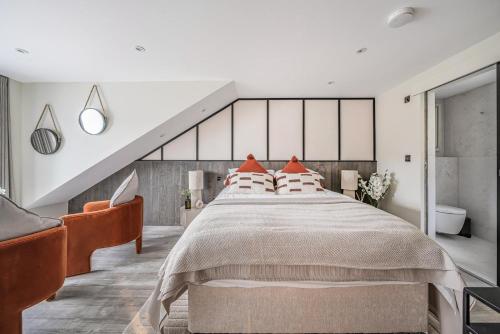 a bedroom with a large bed with orange pillows at 3 Bed in Looe oc-j29456 in Looe