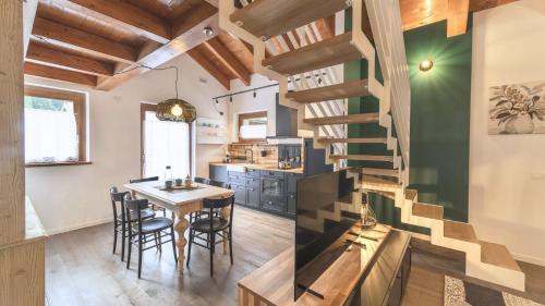 a kitchen and dining room with a spiral staircase at Sesto Senso in Ponte di Legno