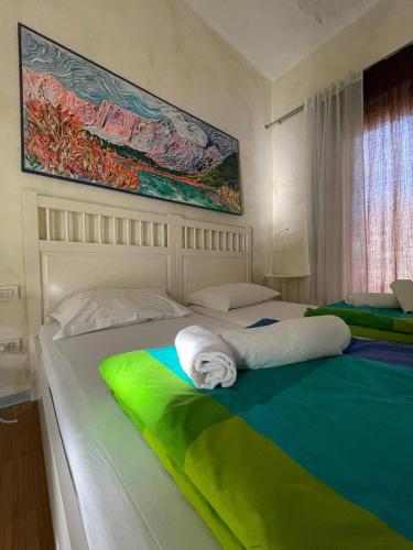 a bedroom with two beds with green and white sheets at Residence Bed&Bike in Moggio Udinese