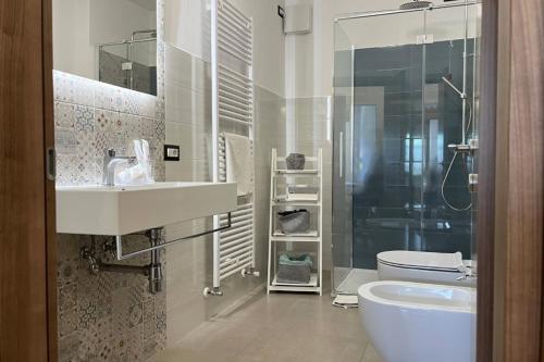 a bathroom with a sink and a toilet and a shower at Casa Castegner - Rooms in Seren del Grappa