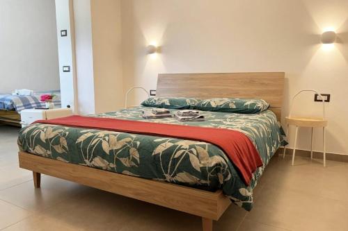 a bedroom with a bed with a wooden head board at Casa Castegner - Rooms in Seren del Grappa