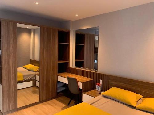 a bedroom with two beds and a desk and a desk at Lunaria Maison - HCM Center Stay in Ho Chi Minh City