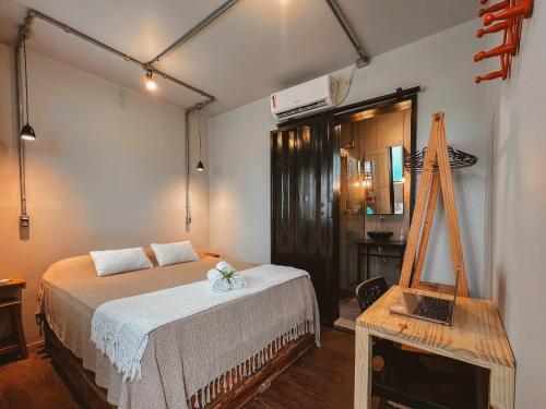 a bedroom with a bed and a table and a mirror at Eco Gostoso in São Miguel do Gostoso